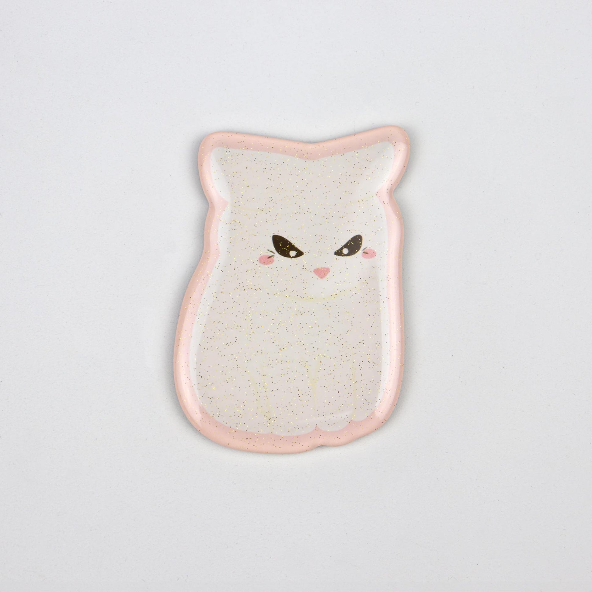 A glittery, translucent acrylic magnet of the angry white cat meme and a pink outline.