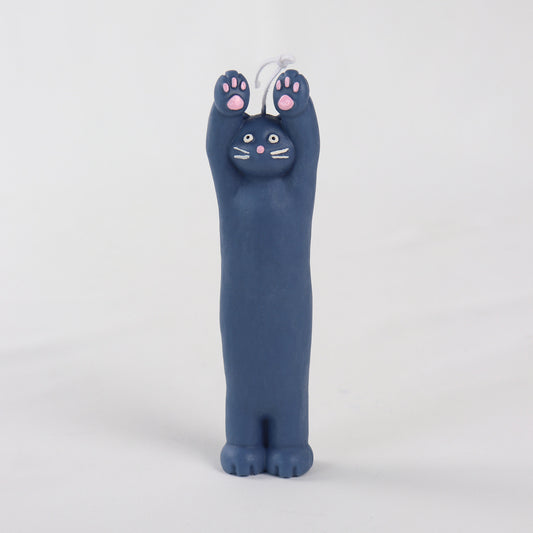 Navy candle in the shape of a cat standing with its hands up