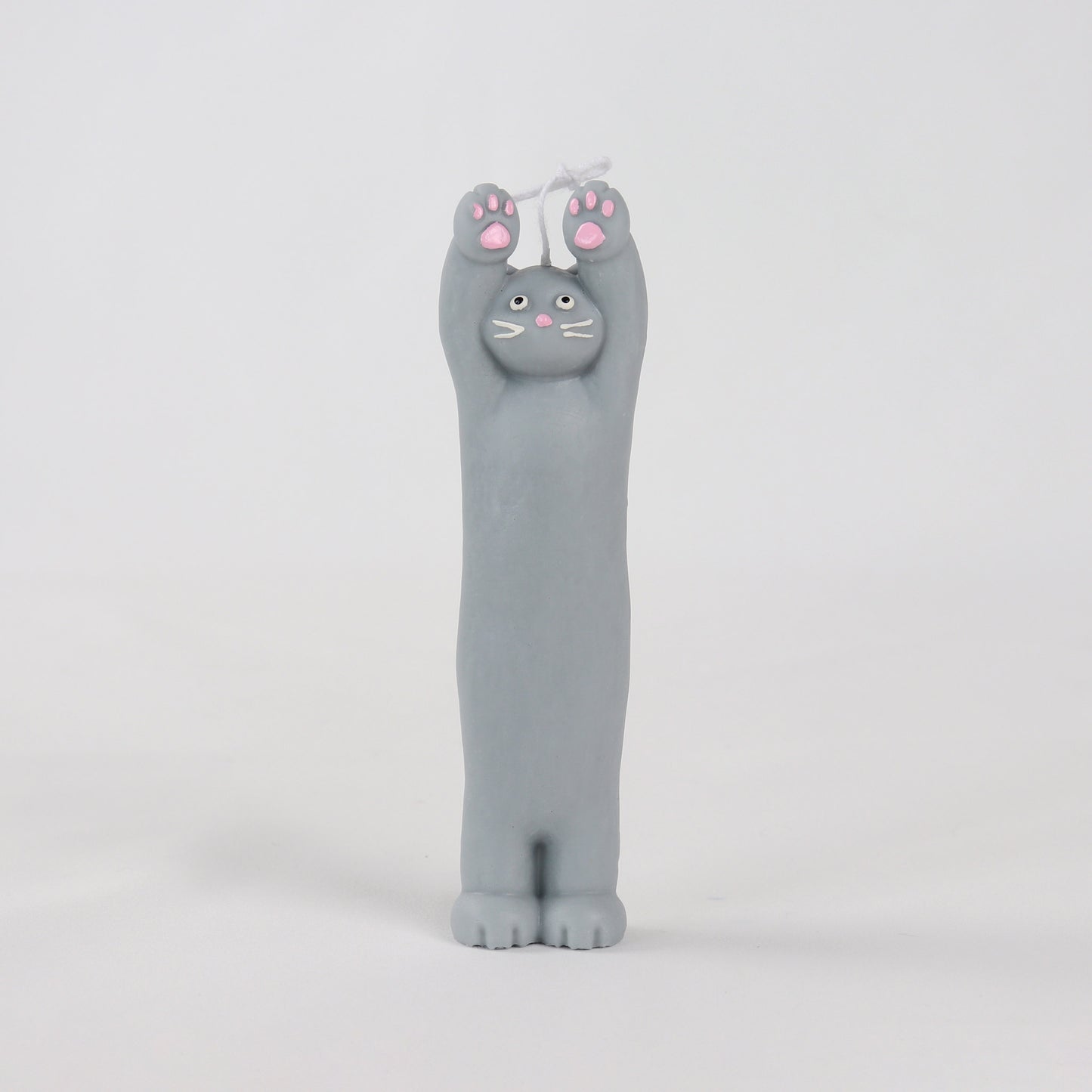 Grey candle in the shape of a cat standing with its paws up