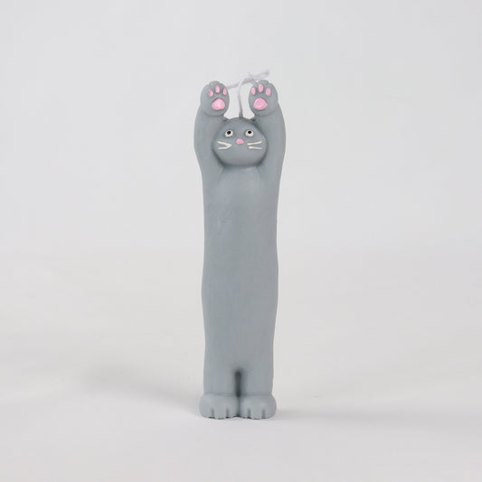 Grey candle in the shape of a cat standing with its paws up