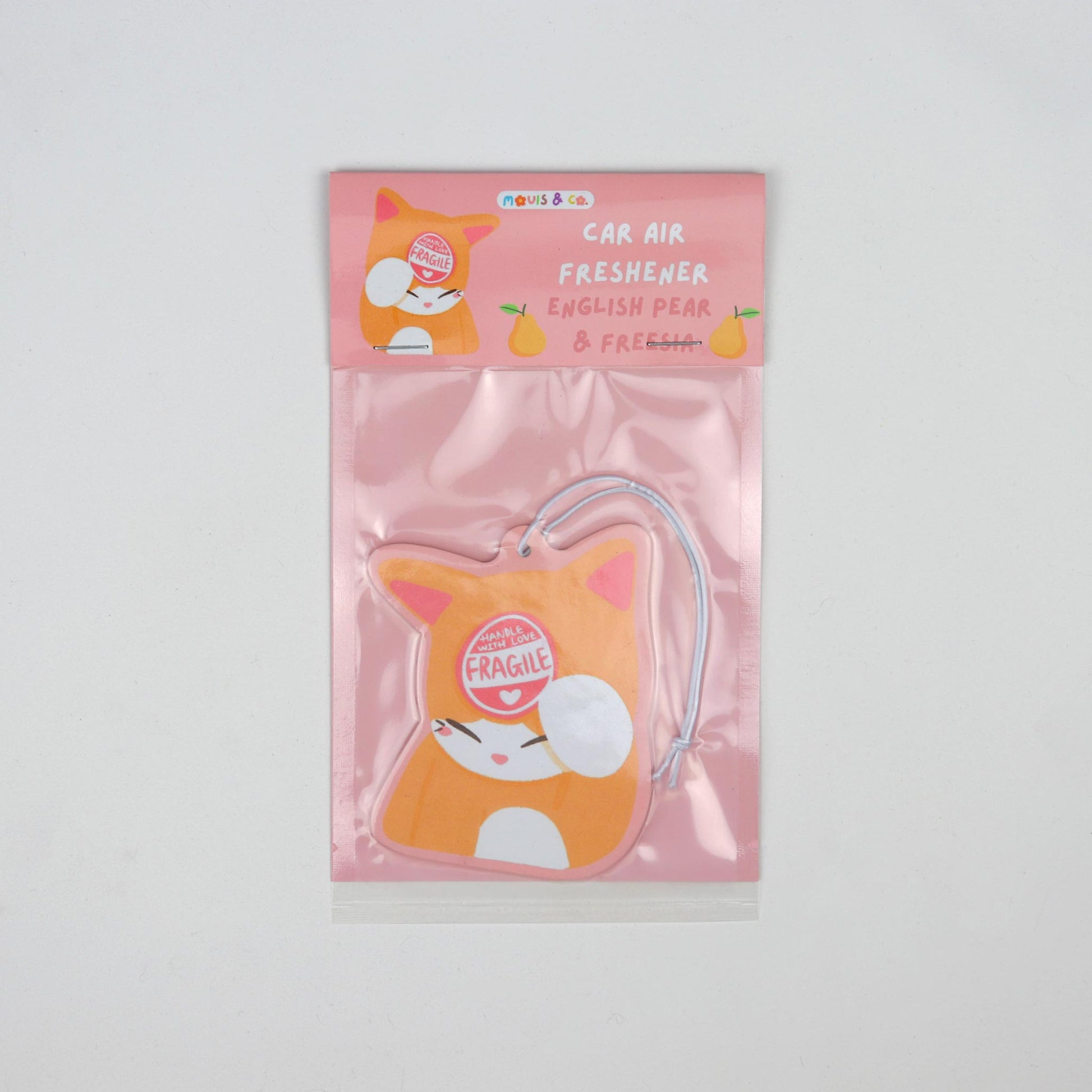 English pear and freesia-scented car air freshener featuring an orange cat with a “Handle with Care – I'm Fragile” sticker, designed by Melbourne artists Mouis Land. Packaged in a pink pouch.