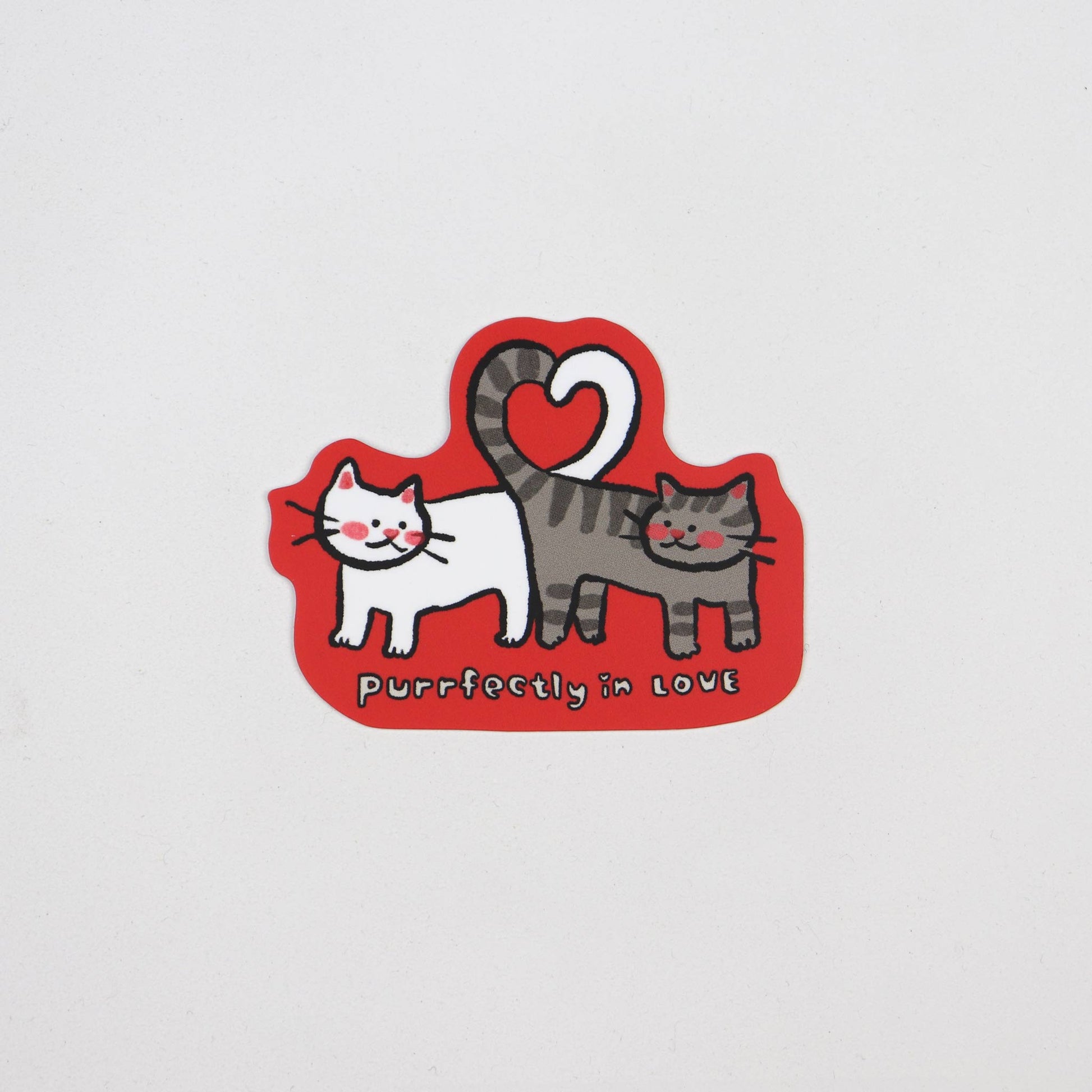 Sticker of two cats making a heart shape out of their tails