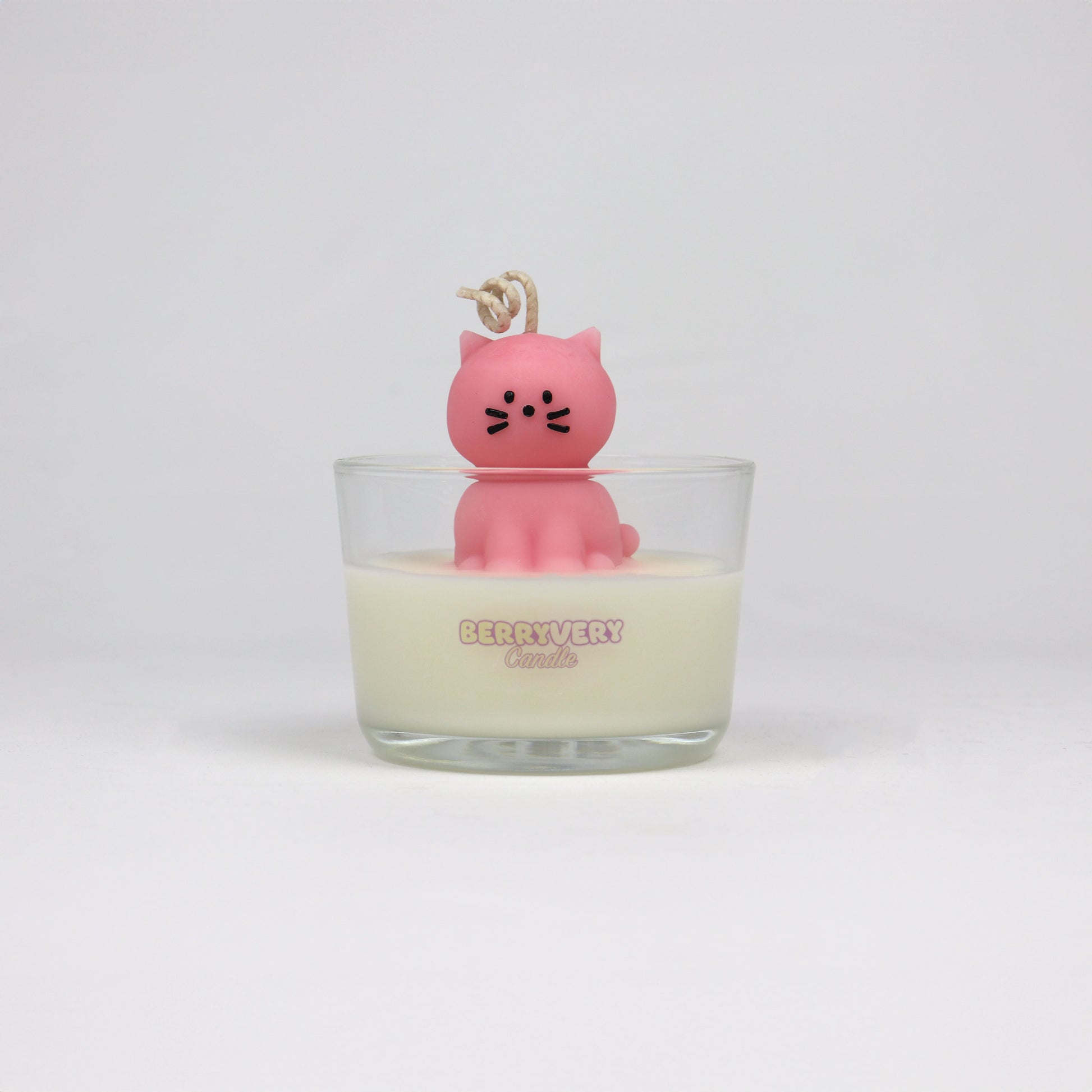 Pink cat-shaped candle sitting in a glass jar, handmade in Brisbane with soy wax and cotton wick.