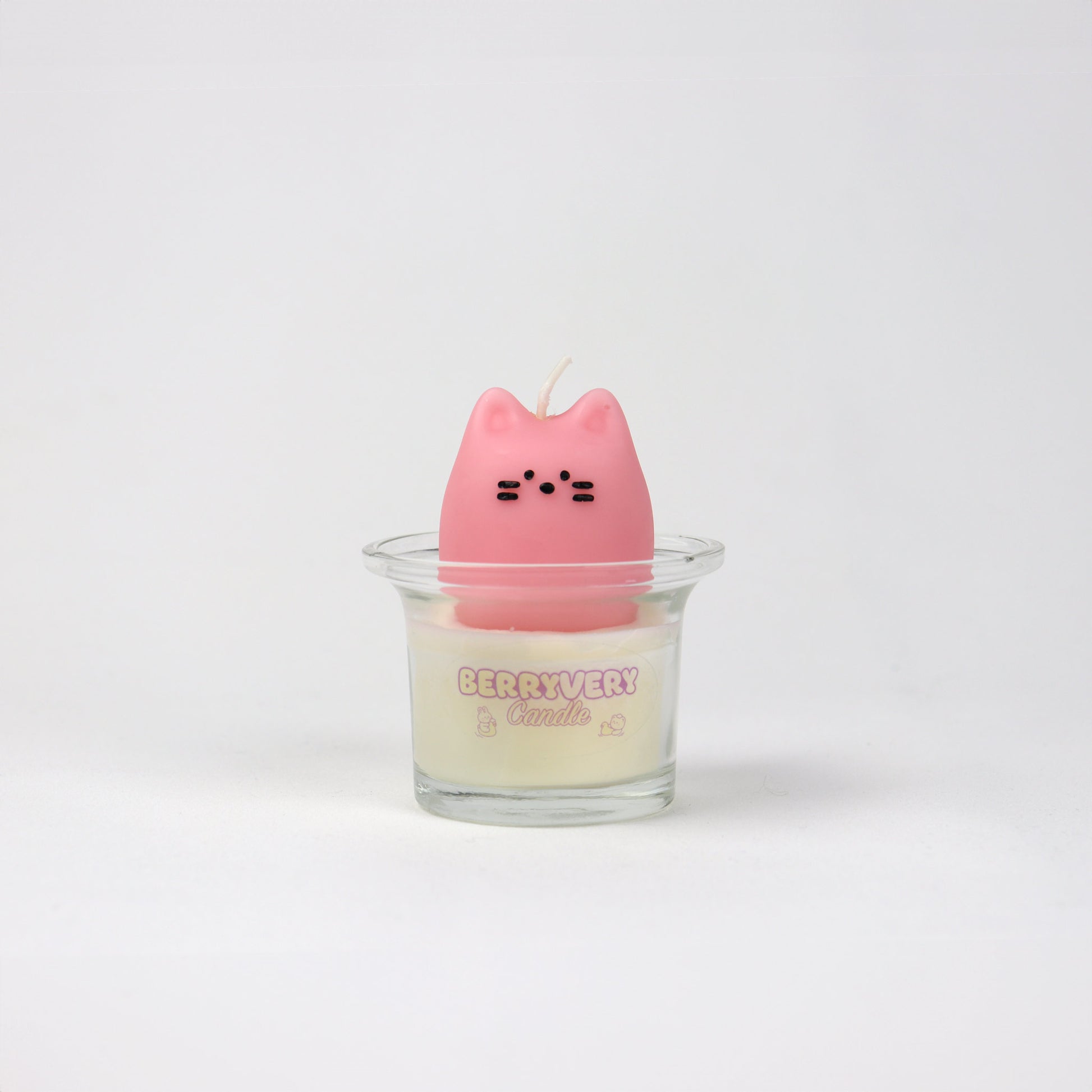 A pink, cat-shaped candle with a clear container, presumably wax, for a home fragrance product.