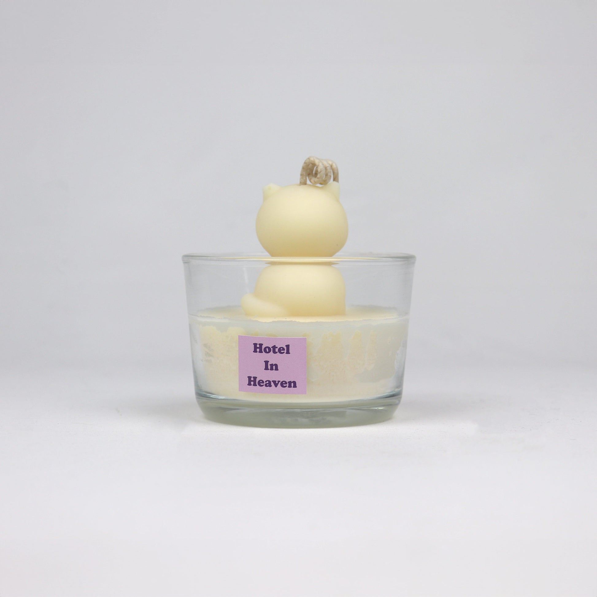 Back of white cat-shaped candle sitting in a clear glass jar, handmade in Brisbane from soy wax with a cotton wick.