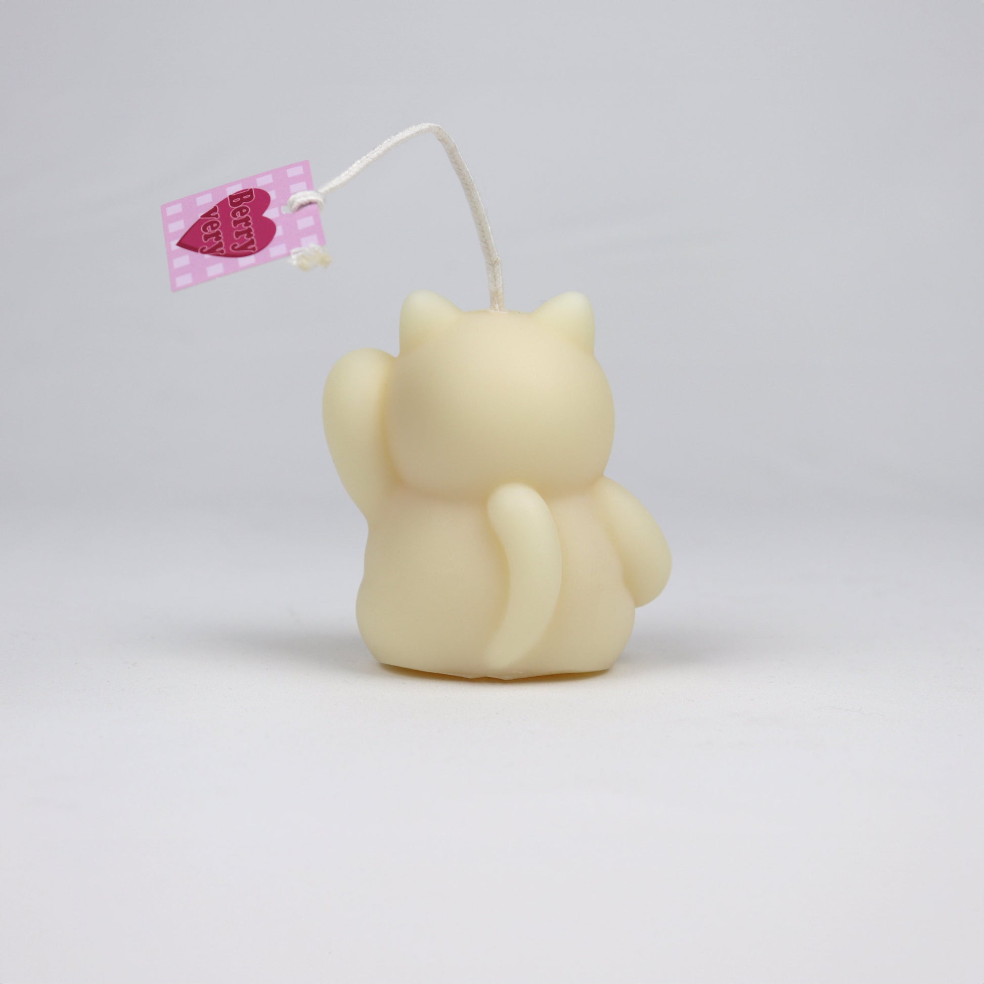 Back of white handmade lucky cat candle with cotton wick, soy-based and scented, made in Brisbane