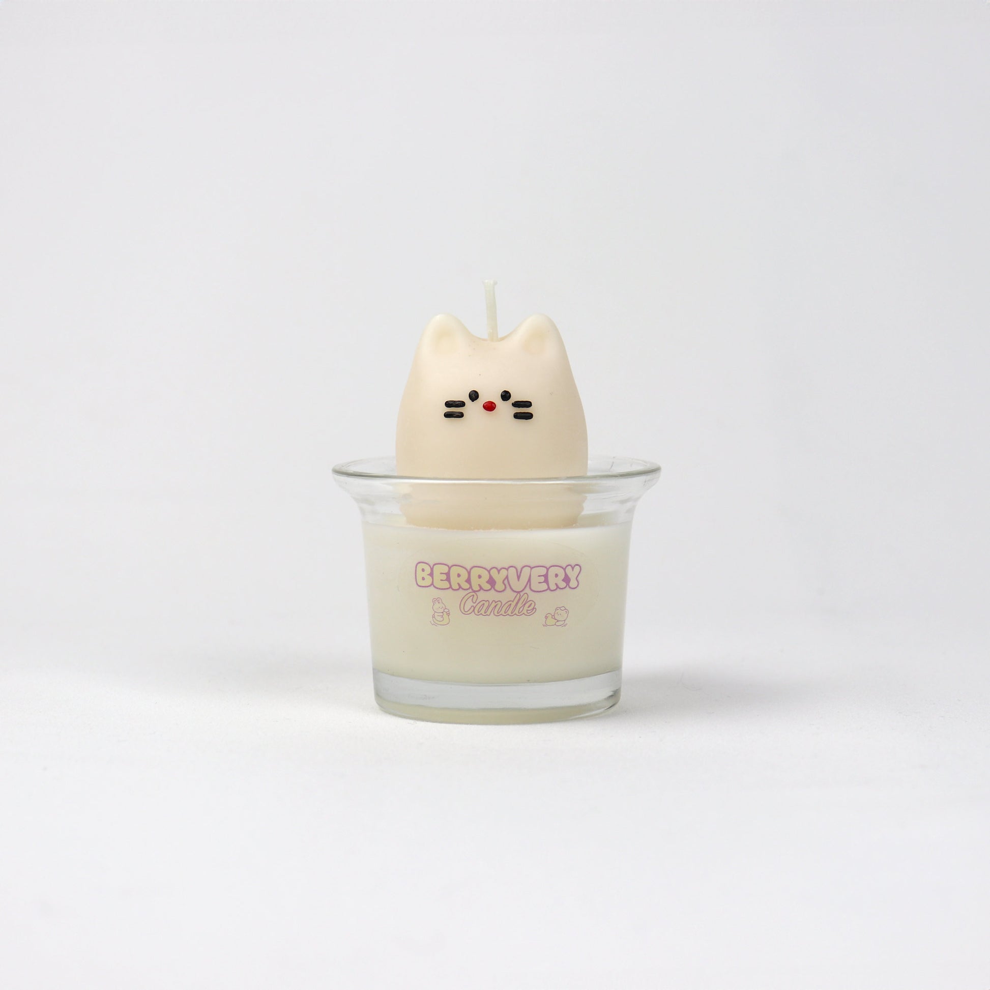 A white mini candle shaped like a cat with a wax layer, possibly for a children's room or as a playful home accessory.