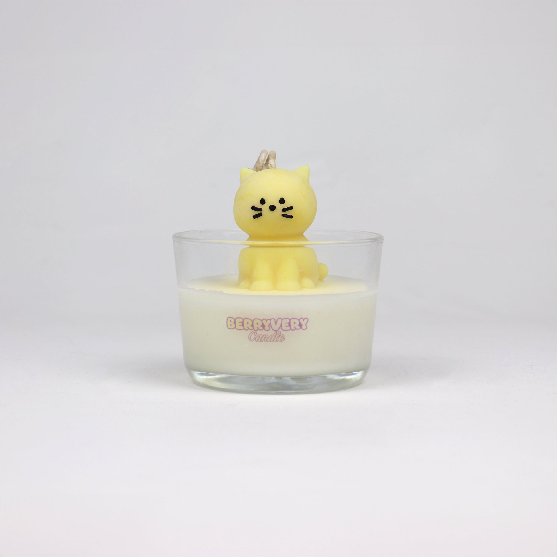 Yellow cat-shaped soy wax candle sitting in a glass jar, handmade in Brisbane with a cotton wick and light scent.