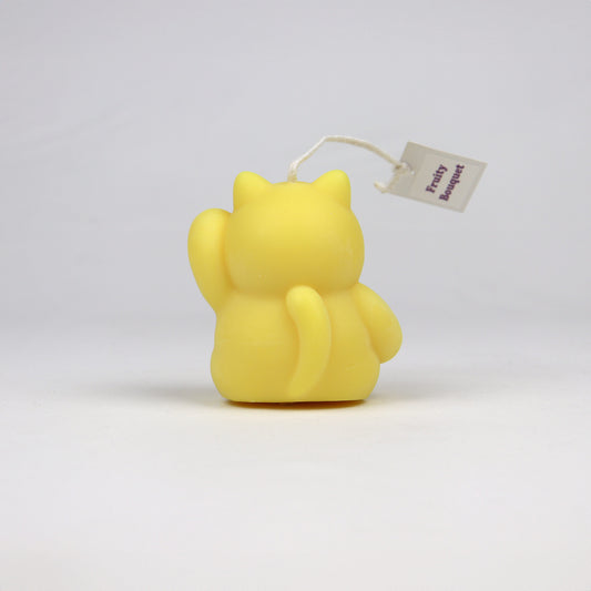 Back of yellow handmade lucky cat candle with cotton wick, soy-based and scented, made in Sydney