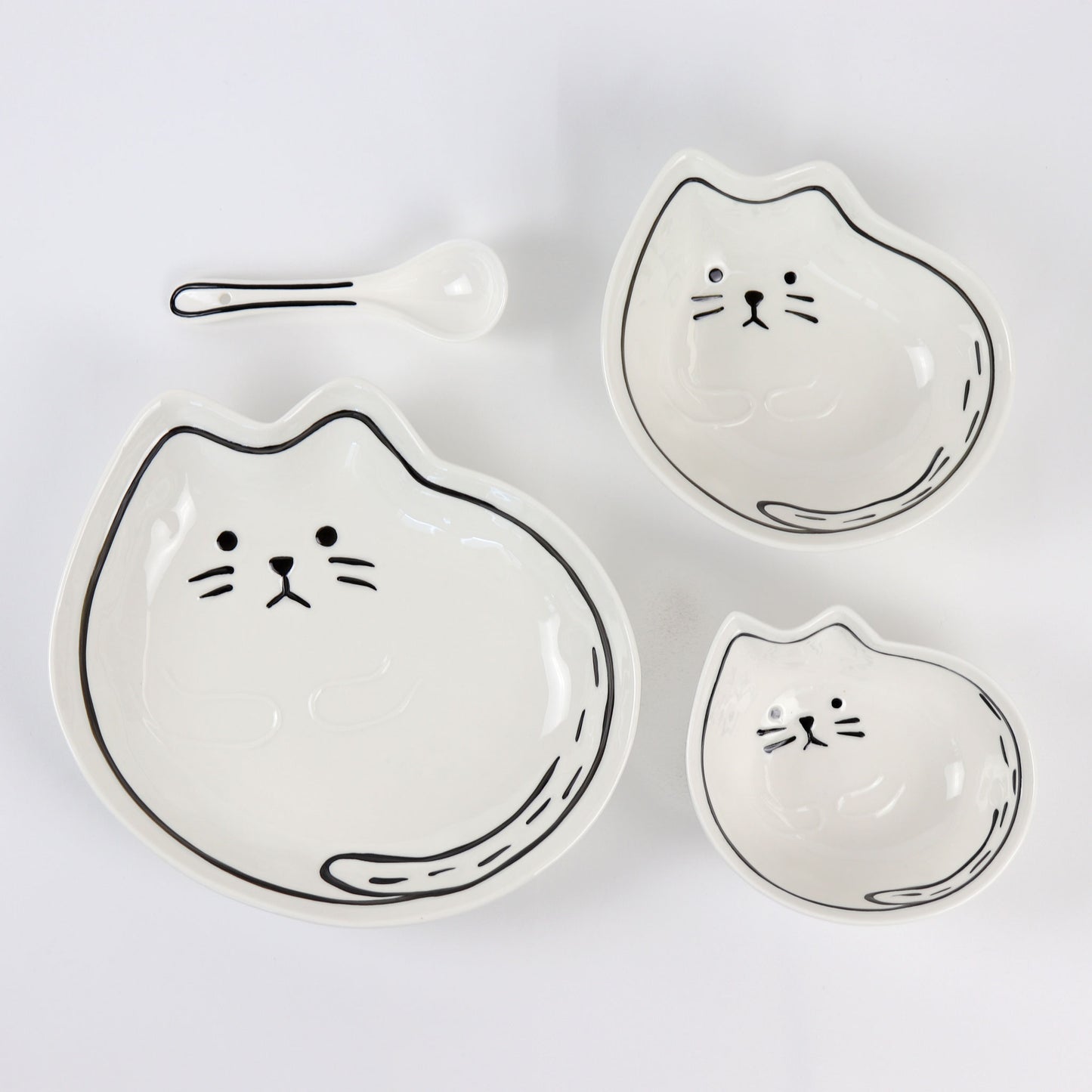 top view of four piece cat bowl and plate set