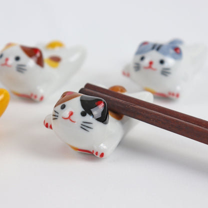 cute ceramic cat chopstick rest with chopstick resting on it