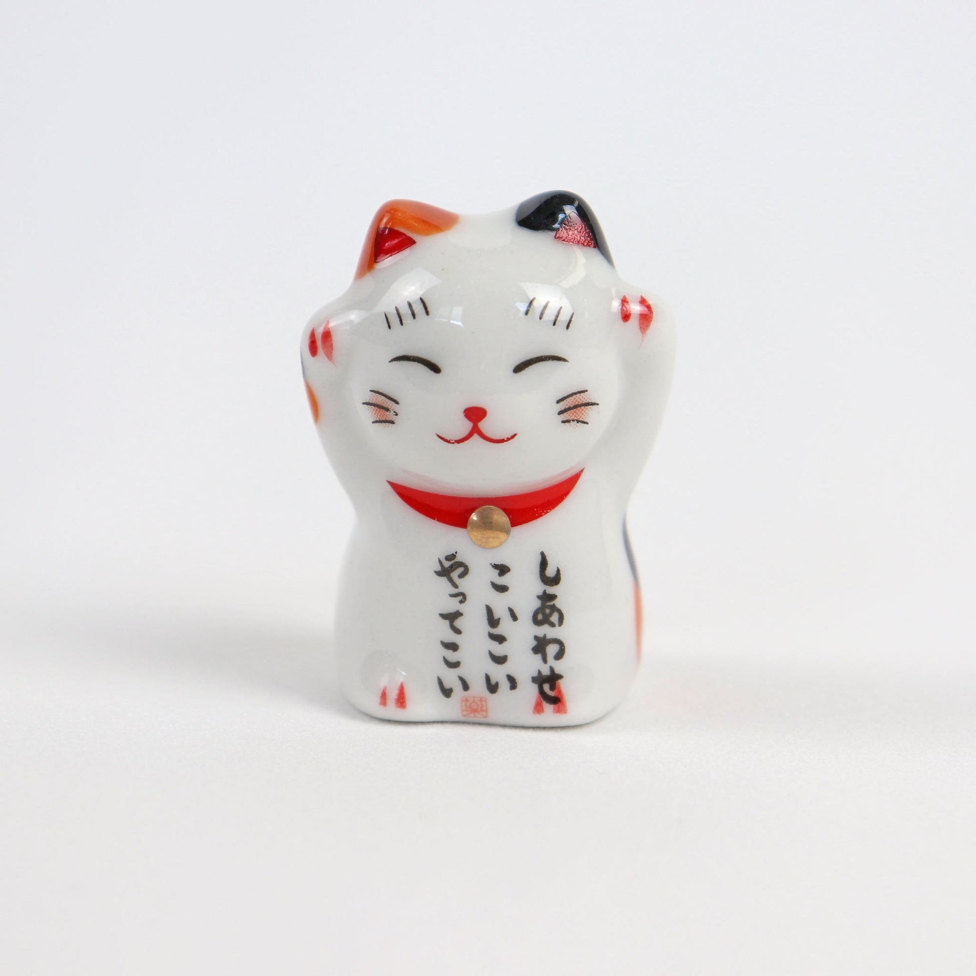 lucky cat with arms up chopstick rest