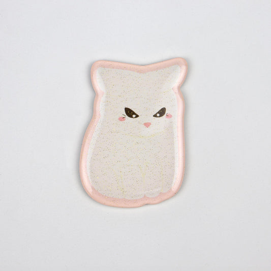 A glittery, translucent acrylic magnet of the angry white cat meme and a pink outline.