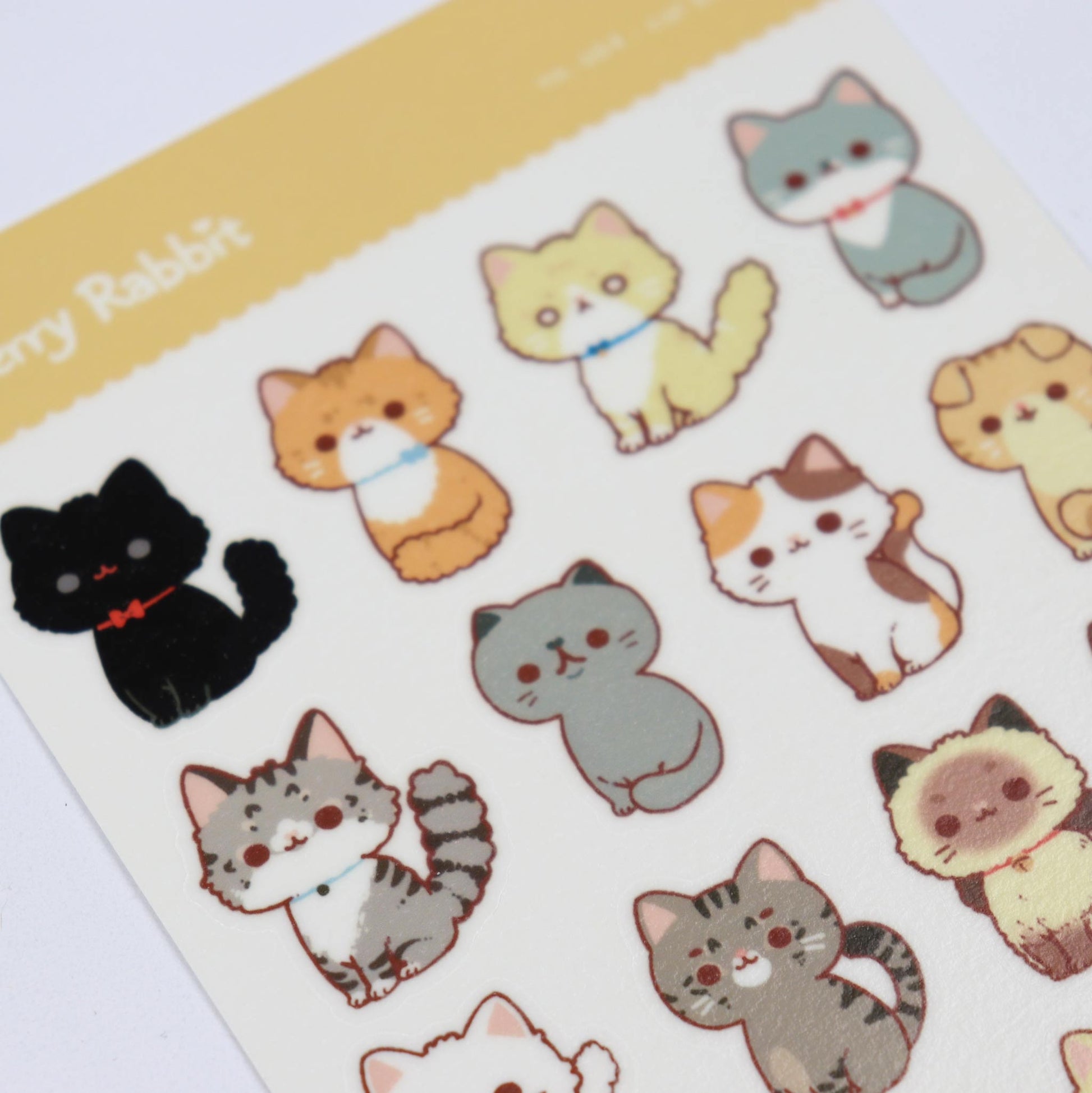Sheet of cat-shaped stickers with various colors on a white background