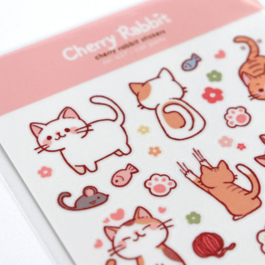 Close up of sticker sheet of cheeky cat cartoons