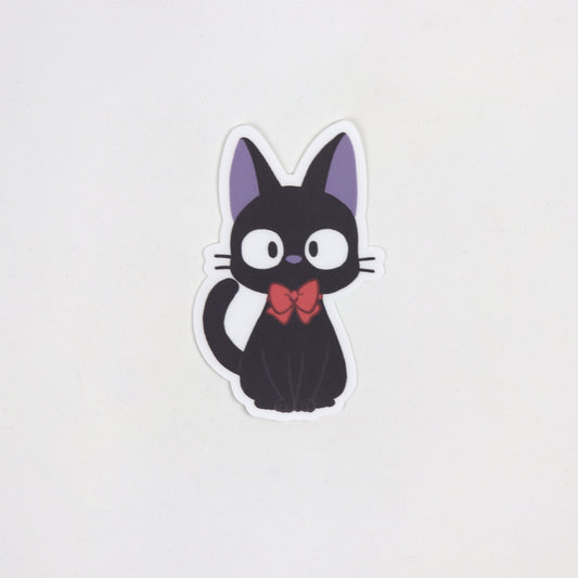 Cute fan art sticker of Jiji the black cat from Kiki’s Delivery Service, with wide eyes and upright ears. Matte, waterproof, approx. 5cm x 7cm.