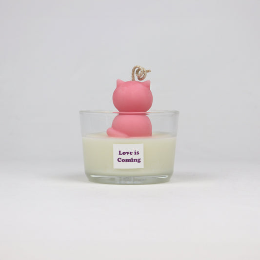 Back of pink cat-shaped candle sitting in a glass jar, handmade in Brisbane with soy wax and cotton wick.