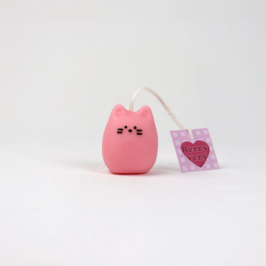 Small pink soy wax pouch candle shaped like a cat with a little nose and tiny whiskers, handmade in Brisbane.