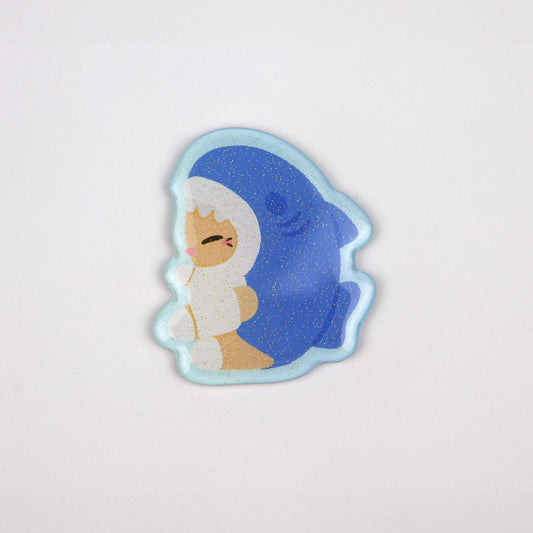 Acrylic magnet of a cartoon cat in a blue shark costume. Ideal for fridges or magnetic boards.