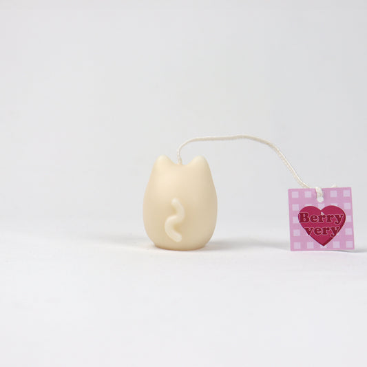 Back of small white cat-shaped pouch candle with red nose and whiskers, handmade in Brisbane from soy wax.
