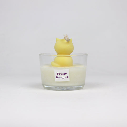 Back of yellow cat-shaped soy wax candle sitting in a glass jar, handmade in Brisbane with a cotton wick and light scent.