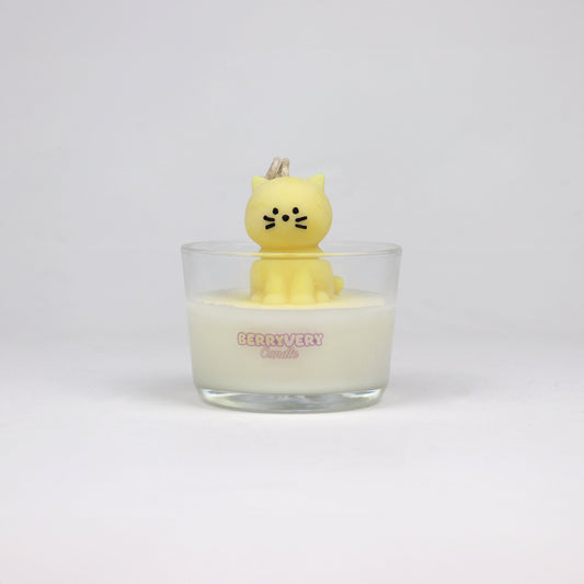 Yellow cat-shaped soy wax candle sitting in a glass jar, handmade in Brisbane with a cotton wick and light scent.