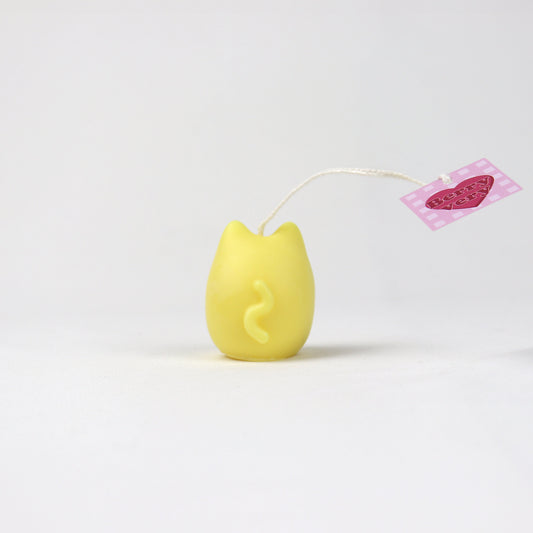 Back of a mini yellow cat-shaped pouch candle made from soy wax with a squiggly tail and BerryVeryCandle tag. Handmade in Brisbane. Available in three colours.