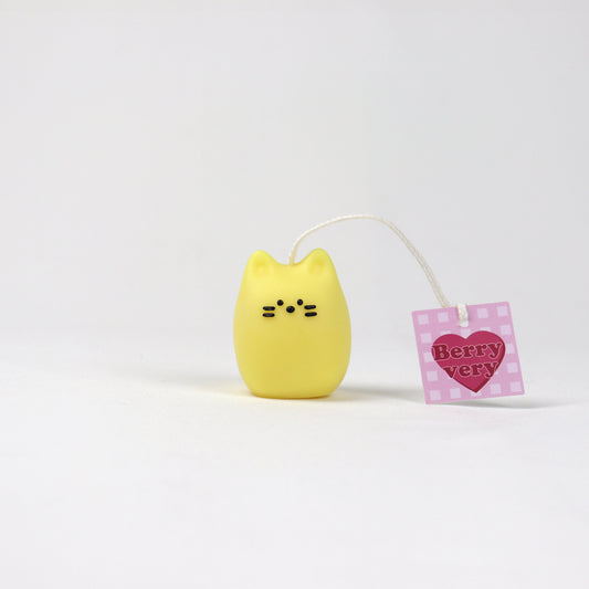 Mini yellow cat-shaped pouch candle made from soy wax with a simple face and BerryVeryCandle tag. Handmade in Brisbane. Available in three colours.